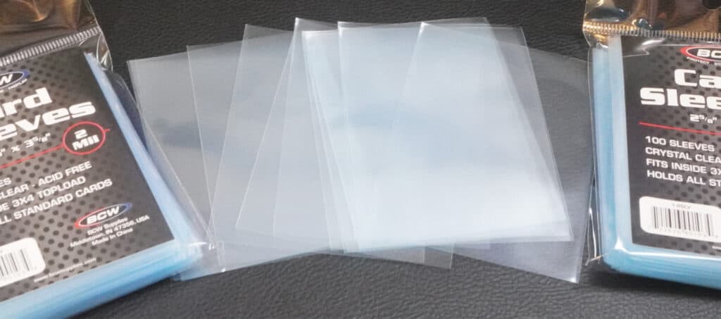 card sleeves spread out with two packages of card sleeves on the outside