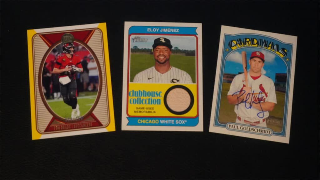 three sports cards laid out next to each other on a black background