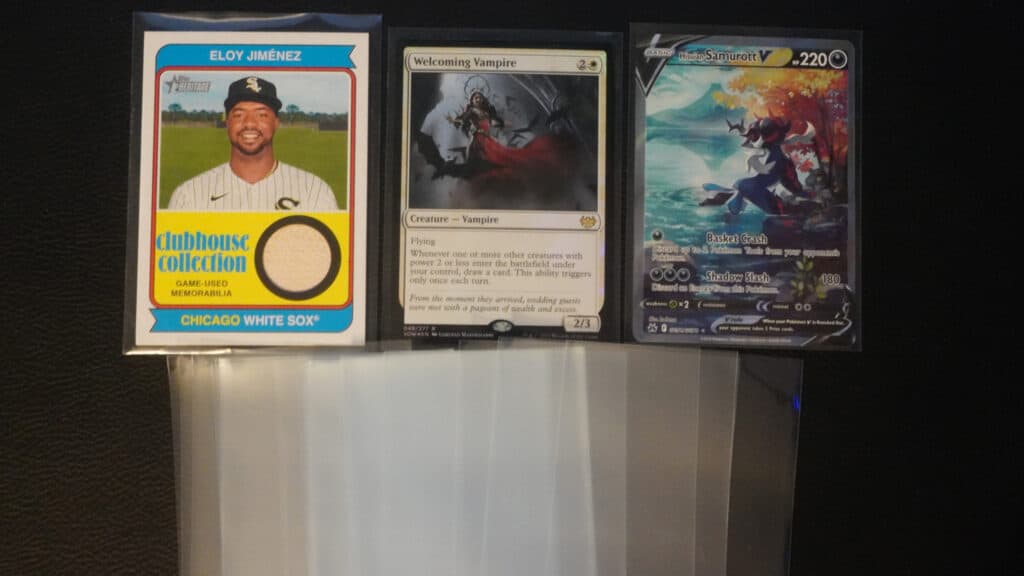 baseball card, magic: the gathering, and Pokemon card laid out next to each other with a spread of card sleeves below them