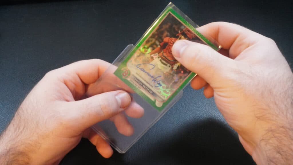 placing a baseball card inside of a toploader