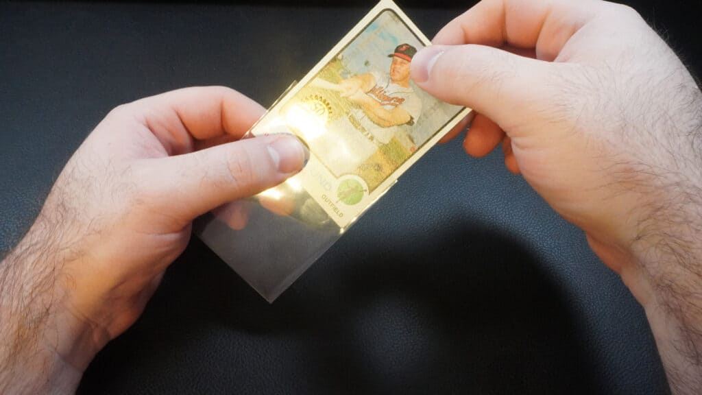 placing a baseball card inside of a card sleeve